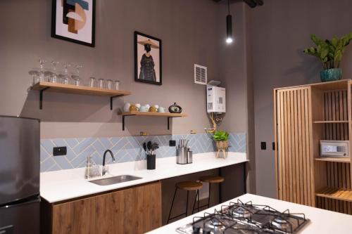 a kitchen with a sink and a counter top at Royal Living Poblado in Medellín