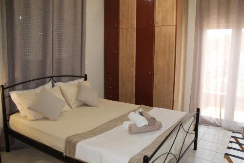 a bedroom with a bed with towels on it at Dabia Apartments in Mirina