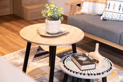 a living room with a table with a vase on it at Royal Living Poblado in Medellín