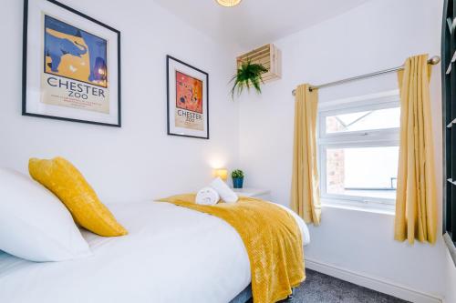 a white bedroom with a bed and a window at Stylish 2-bed home in Chester City-Centre by 53 Degrees Property, ideal for Couples & Small groups, Great Location - Sleeps 5 in Chester
