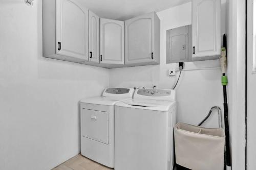 a white laundry room with a washer and dryer at Peaceful 3 Bedroom House with Relaxing Backyard 15 minutes to the Ocean in Hollywood
