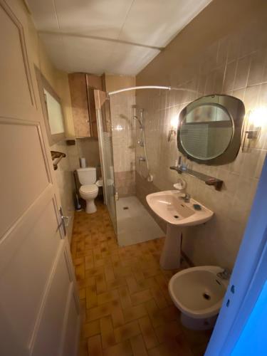 a bathroom with a sink and a toilet and a mirror at NOUVEAU Maison de la place in Jaujac