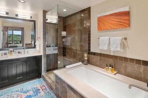 a bathroom with a large tub and a shower at Edgemont 2605 - Luxury Ski-in Ski-out Condo in Steamboat Springs
