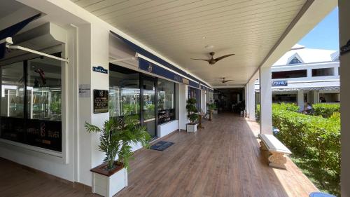 a building with a porch with potted plants on it at Island Escape, Marina Paradise & Beach Adventures in Saint Martin