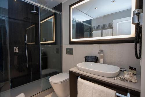 a bathroom with a toilet and a sink and a shower at Hotel Grande Italia in Chioggia