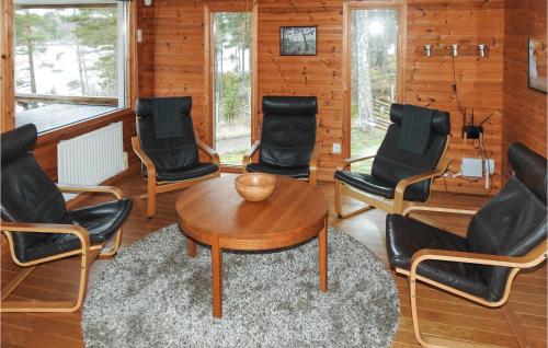 a room with chairs and a table in a room at Pet Friendly Home In Fröseke With Sauna in Fröseke