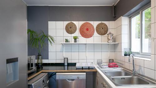 a kitchen with a sink and a counter top at Noordhoek Bliss Beach House in Cape Town