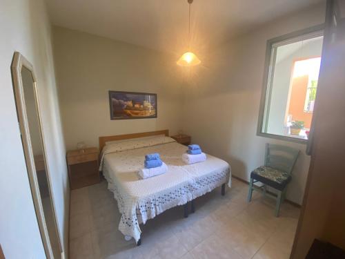 małą sypialnię z łóżkiem z ręcznikami w obiekcie Casa Mary Baia Verde w mieście Baia Verde