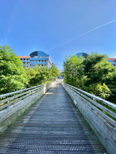 a bridge in a city with trees and buildings at Blue house Bermeo in Bermeo
