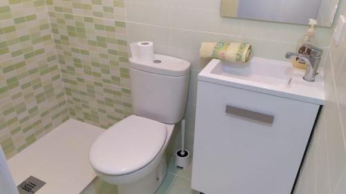 a small bathroom with a toilet and a sink at MAR Y PLAYA in A Guarda
