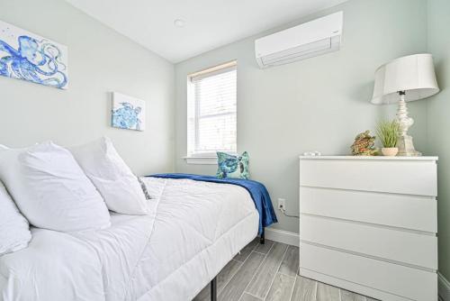 a bedroom with a white bed and a dresser at 318 E Youngs Ave Unit 1 Seaside Serenity Salty Shore Retreat in Wildwood