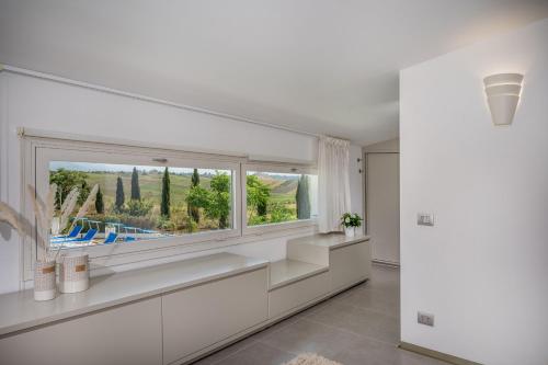 a white living room with a large window at Villa Sikelia in Alcamo