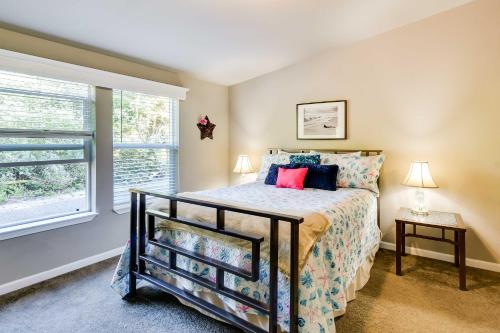 a bedroom with a bed and a window at Ocean Shores Retreat with Porch and Canal Views! in Ocean Shores