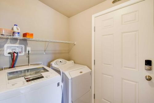 a white washer and dryer in a laundry room at Ocean Shores Retreat with Porch and Canal Views! in Ocean Shores