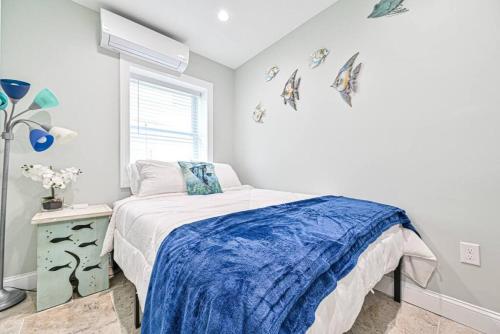 a white bedroom with a bed and a window at 318 E Youngs Ave Unit 4 Charming Salty Shore Retreat Your Perfect Getaway in Wildwood