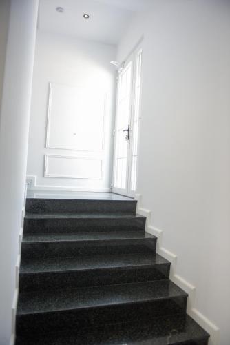 a staircase leading to a door in a building at Hotel Royal in Shkodër