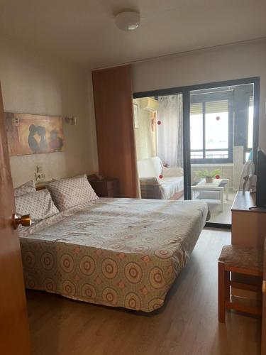 um quarto com uma cama grande e uma sala de estar em Apartamento kuki en Rincón de Loix em Benidorm