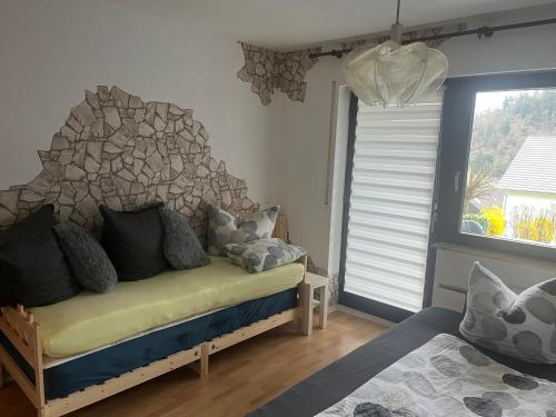 a bedroom with a bed in a room with a window at Mira in Gernsbach