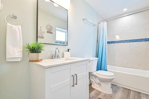 a white bathroom with a sink and a toilet at 318 E Youngs Ave Unit 6 Salty Shore Serenity Beachside Bliss in Wildwood