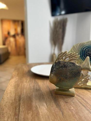 a statue of a fish sitting on top of a table at Marine's luxury home 2 in Votsi