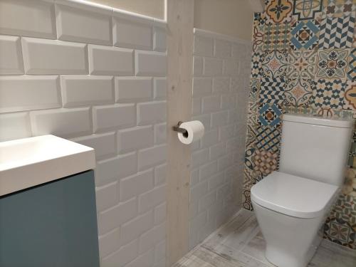 a white bathroom with a toilet and a sink at Picos de Europa Chic & Cool Apartments in Puertas