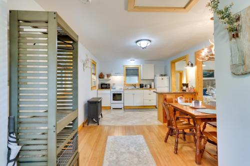 a kitchen and dining room with a table and chairs at East Otis Vacation Rental with Private Deck and BBQ! in East Otis
