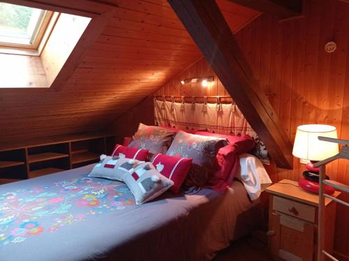 a bedroom with a bed in a attic at Chalet Chez Nous in Domancy