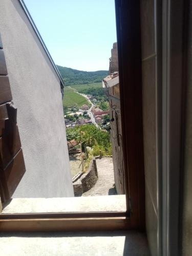 an open window with a view of a city at Rooms Serafin-Lavanda in Motovun