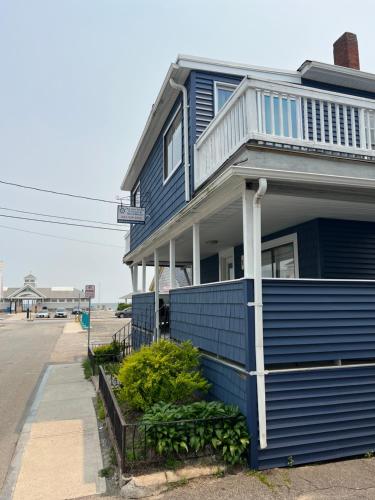 a blue house on the side of a street at Nautical Beach Apartments in Hampton