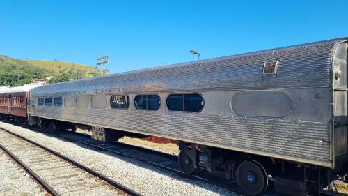 a silver train is sitting on the tracks at Sítio com piscina, área arborizada e lazer in Jacareí