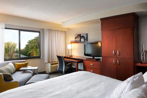 a hotel room with a bed and a desk with a computer at Courtyard by Marriott Corpus Christi in Corpus Christi