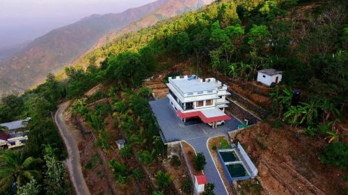 an aerial view of a house on a hill at The Village Courtyard- Organic farm & homestay in Pīrmed