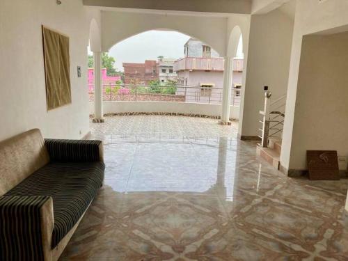 a living room with a couch in the middle of a building at Lagnalaya- Your Next Home in Rājgīr