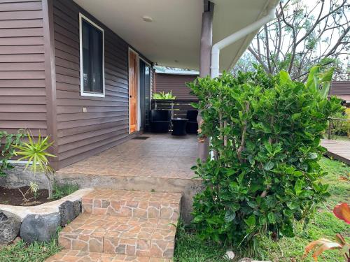 a front porch of a house with a brick walkway at Cabañas Raupa in Hanga Roa