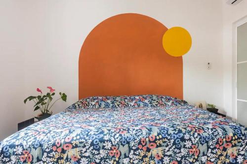 a bed with a colorful comforter in a bedroom at Beautiful Apartment surrounded by nature w/Pool in Cancún