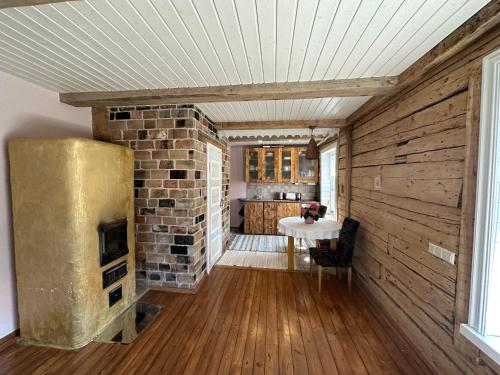 a living room with a brick fireplace and a table at Sadama Apartement Haapsalu in Haapsalu