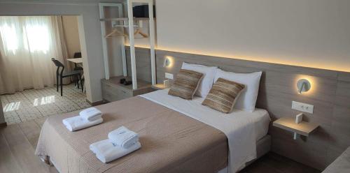 a bedroom with a large bed with towels on it at Sea Breeze in Kalamaki Chanion