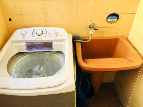 uma máquina de lavar roupa e um lavatório na casa de banho em Hostel Estação Maracanã no Rio de Janeiro