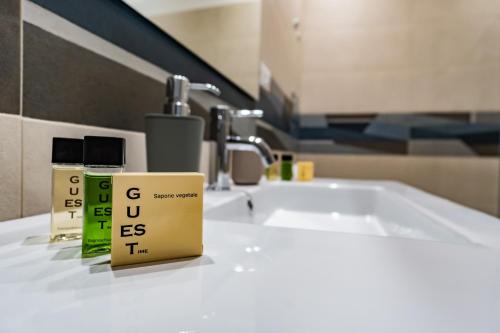 a bathroom sink with two boxes on a counter at Appartamenti Petali Di Rosa in Custonaci