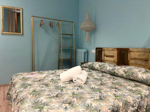 a bedroom with a bed with two towels on it at Hotel Nice in Viareggio