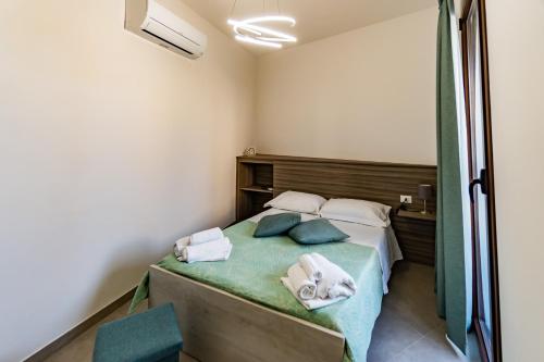 a bedroom with a bed with towels on it at Appartamenti Petali Di Rosa in Custonaci