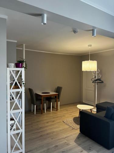 a living room with a table and chairs at Kati Söögituba & Majutus in Emmaste