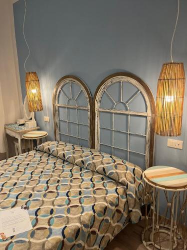 a bedroom with a bed and two tables and two lamps at Hotel Nice in Viareggio