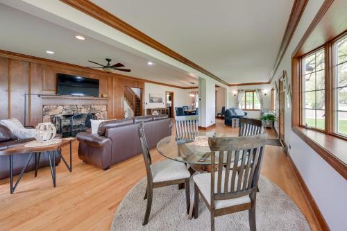 a living room with a table and a couch at Pistakee Lake Estate with Boat Dock and Hot Tub! in Johnsburg