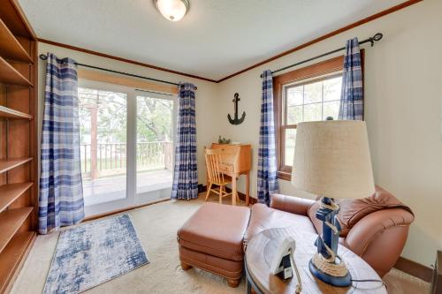 a living room with a couch and a table with a lamp at Pistakee Lake Estate with Boat Dock and Hot Tub! in Johnsburg