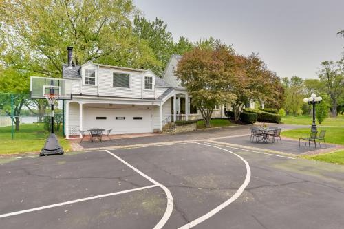 an empty basketball court in front of a house at Pistakee Lake Estate with Boat Dock and Hot Tub! in Johnsburg