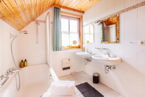 a bathroom with a tub and a sink and a bath tub at Ferienhaus Nora in Sankt Kanzian