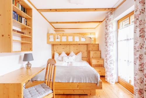 a bedroom with a bed and a desk at Ferienhaus Nora in Sankt Kanzian
