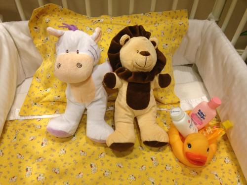 two stuffed animals are sitting on a bed at Taj Campton Place in San Francisco
