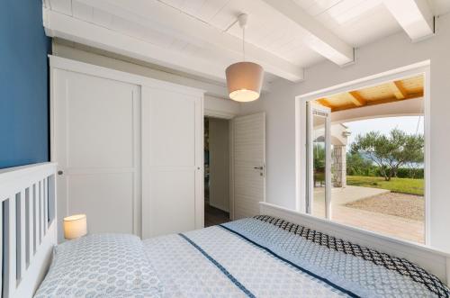 a bedroom with a bed and a large window at Hideaway Crikvenica with Sea view and Private Pool in Crikvenica